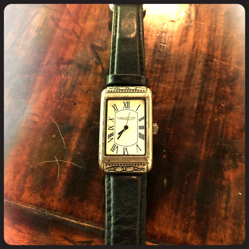 Women’s watch with black leather band.